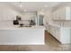 Well-lit kitchen featuring stainless steel appliances, white cabinets, and quartz countertops at 13424 Kibworth Ln, Charlotte, NC 28273