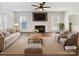 Bright living room features a fireplace, ceiling fan, and a neutral color palette at 13424 Kibworth Ln, Charlotte, NC 28273