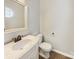 Powder room featuring a marble countertop, traditional fixtures, and tile flooring at 13424 Kibworth Ln, Charlotte, NC 28273
