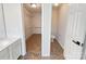 Walk-in closet and attached toilet room featuring tile floors and shelving at 13424 Kibworth Ln, Charlotte, NC 28273