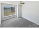 Bright room with large windows, neutral carpet and a ceiling fan at 1419 Deer Forest Dr, Fort Mill, SC 29707