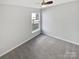 Bright bedroom with neutral walls, gray carpet, and a window providing natural light at 1419 Deer Forest Dr, Fort Mill, SC 29707