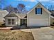 Well-kept home featuring a two car garage, bay window and landscaped lawn at 1419 Deer Forest Dr, Fort Mill, SC 29707