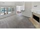 Spacious living room with a fireplace, large windows and an open view to the dining area at 1419 Deer Forest Dr, Fort Mill, SC 29707