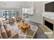 Bright living room featuring neutral tones, a cozy fireplace and views of the dining area at 1419 Deer Forest Dr, Fort Mill, SC 29707