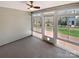 Bright sunroom with concrete flooring, surrounded by windows offering views of the backyard at 1419 Deer Forest Dr, Fort Mill, SC 29707