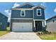 Charming two-story home features a stone facade, white garage door, and manicured landscaping at 1421 31St Ne St, Conover, NC 28613