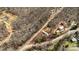 A high-angle view shows the property surrounded by a mix of trees and natural beauty at 144 Cherokee Ln, New London, NC 28127