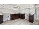 Kitchen featuring modern floors, updated white cabinets, and brown lower cabinets and hardware at 144 Cherokee Ln, New London, NC 28127