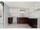 Kitchen featuring modern floors, updated white cabinets, and brown lower cabinets and hardware at 144 Cherokee Ln, New London, NC 28127