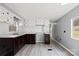 Kitchen featuring modern floors, updated white cabinets, and brown lower cabinets and hardware at 144 Cherokee Ln, New London, NC 28127