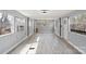 Bright living room with ample natural light and modern floors flowing into the kitchen at 144 Cherokee Ln, New London, NC 28127