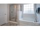 Beautiful bathroom featuring a large soaking tub, separate shower, and window for natural light at 149 High Rock Ct # 02, Statesville, NC 28677