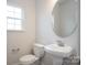 Bathroom features modern fixtures, a pedestal sink, tiled floors and a window for natural light at 149 High Rock Ct # 02, Statesville, NC 28677