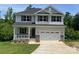 Charming two-story home featuring a covered front porch, two-car garage, and landscaped front yard at 149 High Rock Ct # 02, Statesville, NC 28677