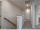 Upstairs hallway with carpet and white doors leading to various rooms at 149 High Rock Ct # 02, Statesville, NC 28677
