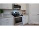New kitchen featuring stainless steel appliances, granite countertops, white cabinets, and hardwood flooring at 149 High Rock Ct # 02, Statesville, NC 28677