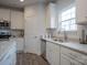Kitchen boasts white cabinets, stainless appliances, granite counters, double bowl sink, and hardwood floors at 149 High Rock Ct # 02, Statesville, NC 28677