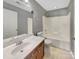 Bathroom featuring a sink vanity, toilet, and tub and shower combo with neutral gray walls at 15120 Callow Forest Dr, Charlotte, NC 28273
