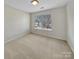 Bright, neutral bedroom with carpet, a window, and a ceiling light at 15120 Callow Forest Dr, Charlotte, NC 28273