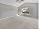 Spacious bedroom features neutral gray walls, carpeted floor, natural light from the window at 15120 Callow Forest Dr, Charlotte, NC 28273