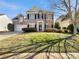 Traditional two-story brick home with a well-manicured lawn and attached two-car garage at 15120 Callow Forest Dr, Charlotte, NC 28273