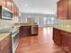 Open kitchen showcases stainless steel appliances, granite countertops, and hardwood floors at 15120 Callow Forest Dr, Charlotte, NC 28273