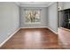 Empty room with hardwood floors and a large window with blinds at 15120 Callow Forest Dr, Charlotte, NC 28273