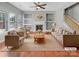 Bright living room with fireplace, built-in shelves, hardwood floors, and comfortable seating arrangement at 15120 Callow Forest Dr, Charlotte, NC 28273