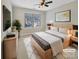 Cozy bedroom featuring a large window, modern furniture, and stylish decor elements at 15120 Callow Forest Dr, Charlotte, NC 28273