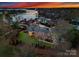 Breathtaking aerial view of the property with lake access, lush greenery, and a picturesque neighborhood at 17429 Staysail Ct, Cornelius, NC 28031