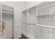 Walk-in closet with custom shelves, cabinets, and drawers at 17429 Staysail Ct, Cornelius, NC 28031