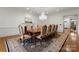 Formal dining room with a decorative chandelier, a fireplace, and a large area rug at 17429 Staysail Ct, Cornelius, NC 28031