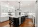 Modern kitchen with stainless steel appliances, a large island, and custom cabinetry providing ample storage and workspace at 17429 Staysail Ct, Cornelius, NC 28031