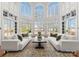 Bright living room features soaring windows, neutral décor, and stylish furnishings, creating a welcoming atmosphere at 17429 Staysail Ct, Cornelius, NC 28031