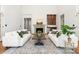 Elegant living room with a stone fireplace, tasteful decor, and comfortable seating perfect for relaxation and entertaining at 17429 Staysail Ct, Cornelius, NC 28031