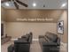 Spacious movie room featuring comfortable seating and modern ceiling fan, virtually staged at 17429 Staysail Ct, Cornelius, NC 28031