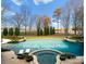 Inviting pool with pristine landscaping and beautiful greenery create an outdoor oasis, virtually staged at 17429 Staysail Ct, Cornelius, NC 28031