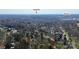 Expansive aerial view of a neighborhood showcasing tree-lined streets and distant city landmarks SouthPark and Montford at 1817 Jameston Dr, Charlotte, NC 28209