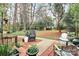Relaxing backyard seating area with wicker chair, patio, and lush landscaping in a serene, wooded setting at 1817 Jameston Dr, Charlotte, NC 28209