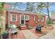 Backyard patio with charming brickwork, cozy seating, and mature landscaping at 1817 Jameston Dr, Charlotte, NC 28209