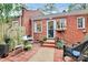 Backyard patio with seating area, brickwork, mature trees, and partial fencing at 1817 Jameston Dr, Charlotte, NC 28209