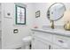 Bathroom featuring a modern vanity, stained-glass window, and a stylish round mirror at 1817 Jameston Dr, Charlotte, NC 28209