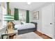Sunlit bedroom featuring hardwood floors, neutral walls, and bright green decor at 1817 Jameston Dr, Charlotte, NC 28209