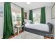 Cozy bedroom featuring hardwood floors, neutral walls, and bright green decor at 1817 Jameston Dr, Charlotte, NC 28209