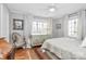 Bedroom with bright windows, neutral decor, and gleaming hardwood floors at 1817 Jameston Dr, Charlotte, NC 28209