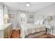 Bedroom with warm lighting, neutral decor, and polished hardwood floors at 1817 Jameston Dr, Charlotte, NC 28209
