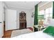 Light-filled bedroom featuring hardwood floors and a decorative secretary desk at 1817 Jameston Dr, Charlotte, NC 28209