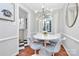 Modern dining room with stylish lighting, a round table with seating, and hardwood floors and natural light at 1817 Jameston Dr, Charlotte, NC 28209