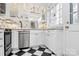 Bright kitchen with stainless steel appliances, black and white flooring, and marble countertops at 1817 Jameston Dr, Charlotte, NC 28209